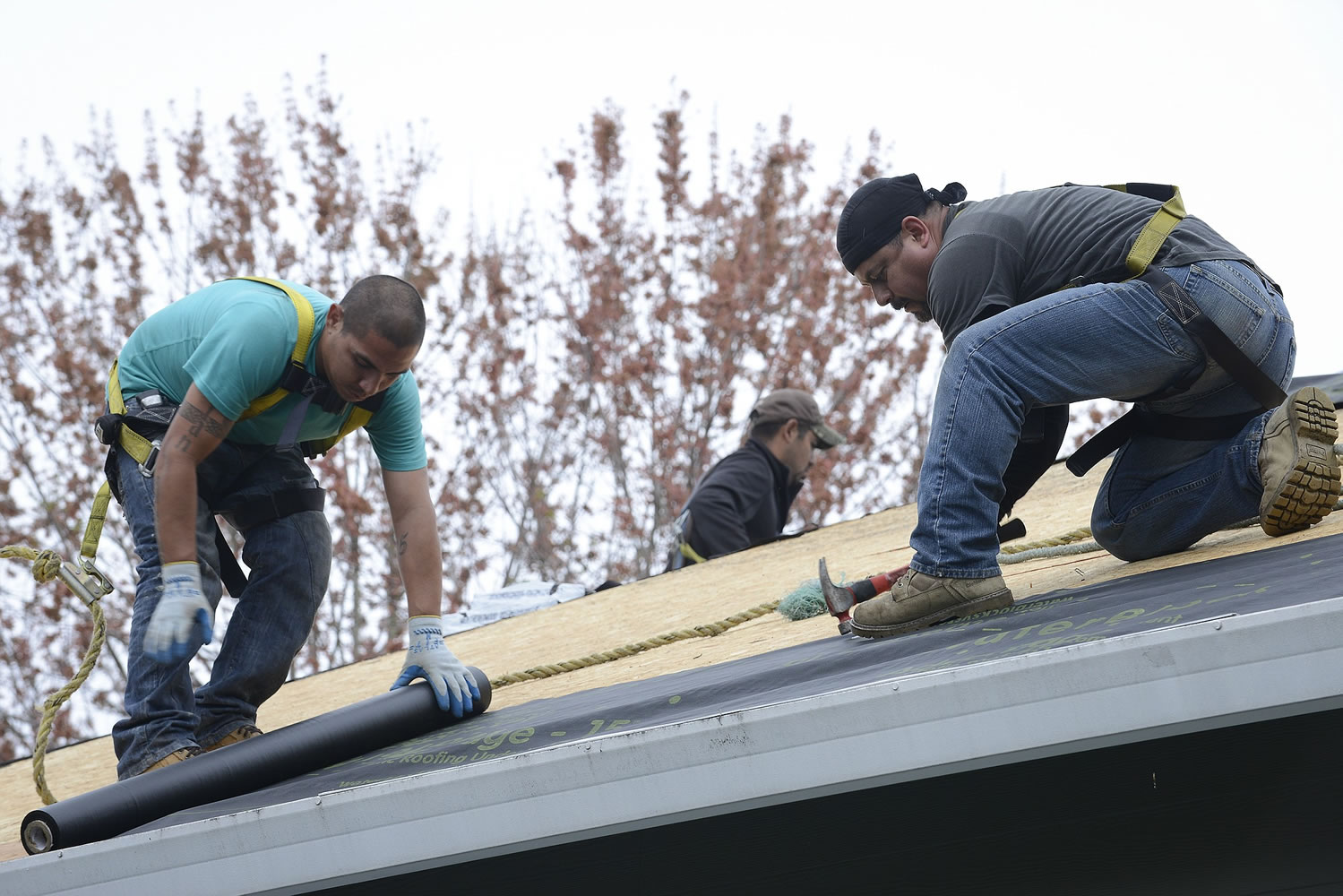Jose Louis, left, and Rocky Robles, employees of Columbia Contracting, roof a Vancouver home under contract with Viirt, an online roofing broker founded by Josh Davis, a former Vancouver resident who established the company in Omaha, Neb.