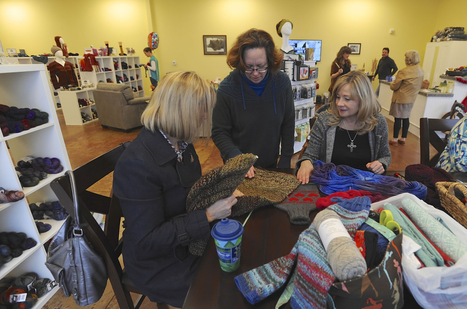 Rosalind Pirkl, from left, Loretta Barber and Laura Harper take part in a class at the Urban Wolves Fibre Arts store in Hazel Dell.