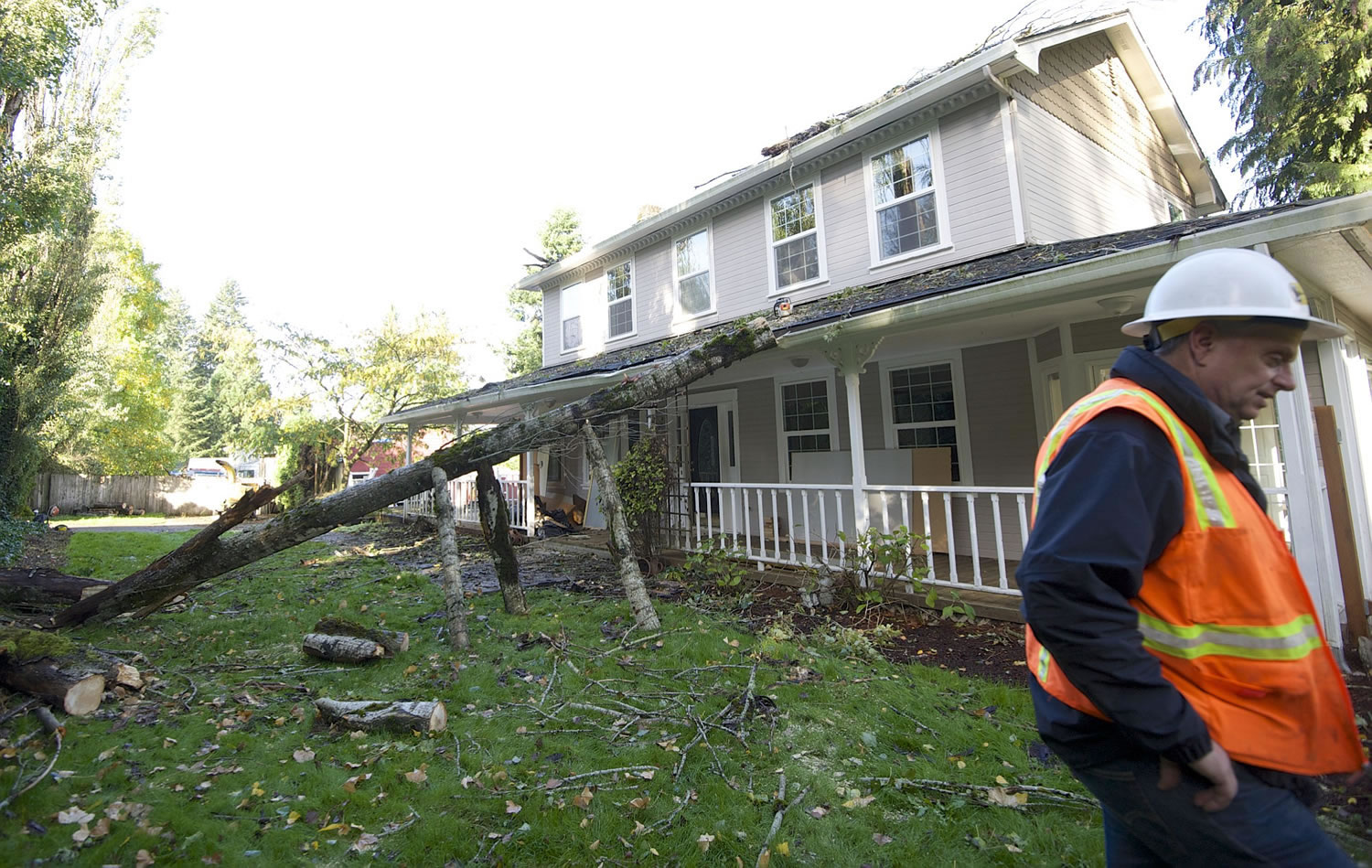 Kirk Ueckert, owner of Timbermans Tree Service, and his crew removed half of a poplar tree that fell on to a northeast Vancouver home Saturday during a wind storm.