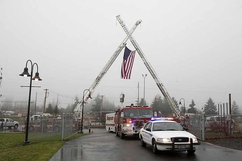 A police escort leads family and friends to the memorial service held Saturday at the Clark County Event Center for Dist. 6 firefighter Rick Streissguth and brother-in-law Doug Jacobsen. The two died in Montana car crash on trip to buy an antique fire truck on Dec.