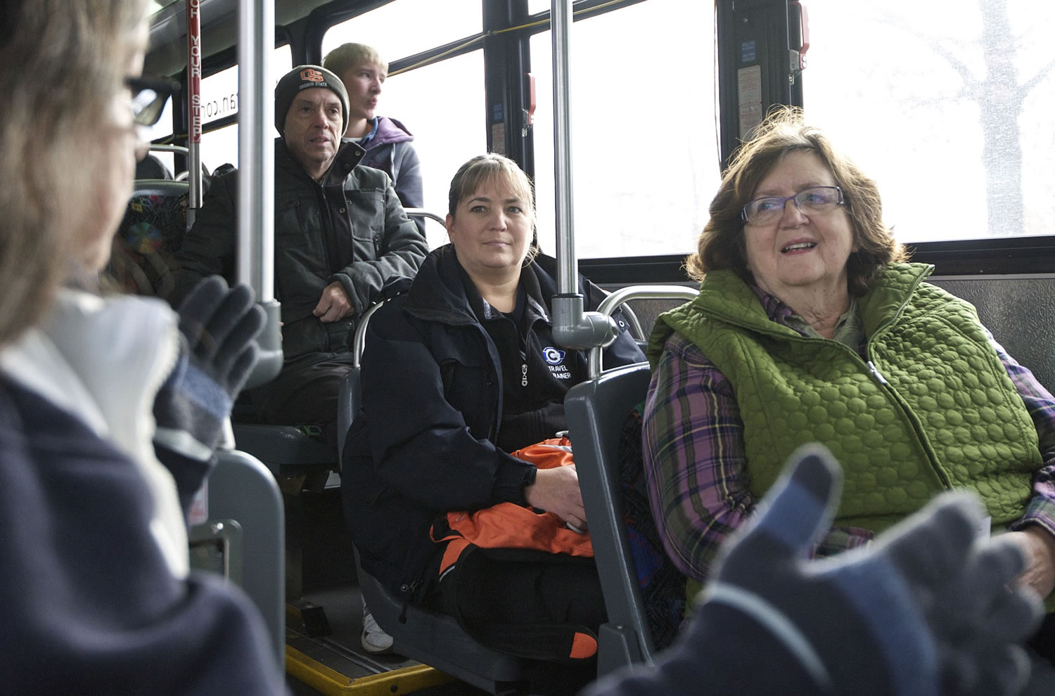 Clark County newcomer Wendy Olmstead, right, receives guidance from C-Tran travel ambassador Virginia Edwards, front left, during a recent trip from Camas to the Westfield Vancouver mall.