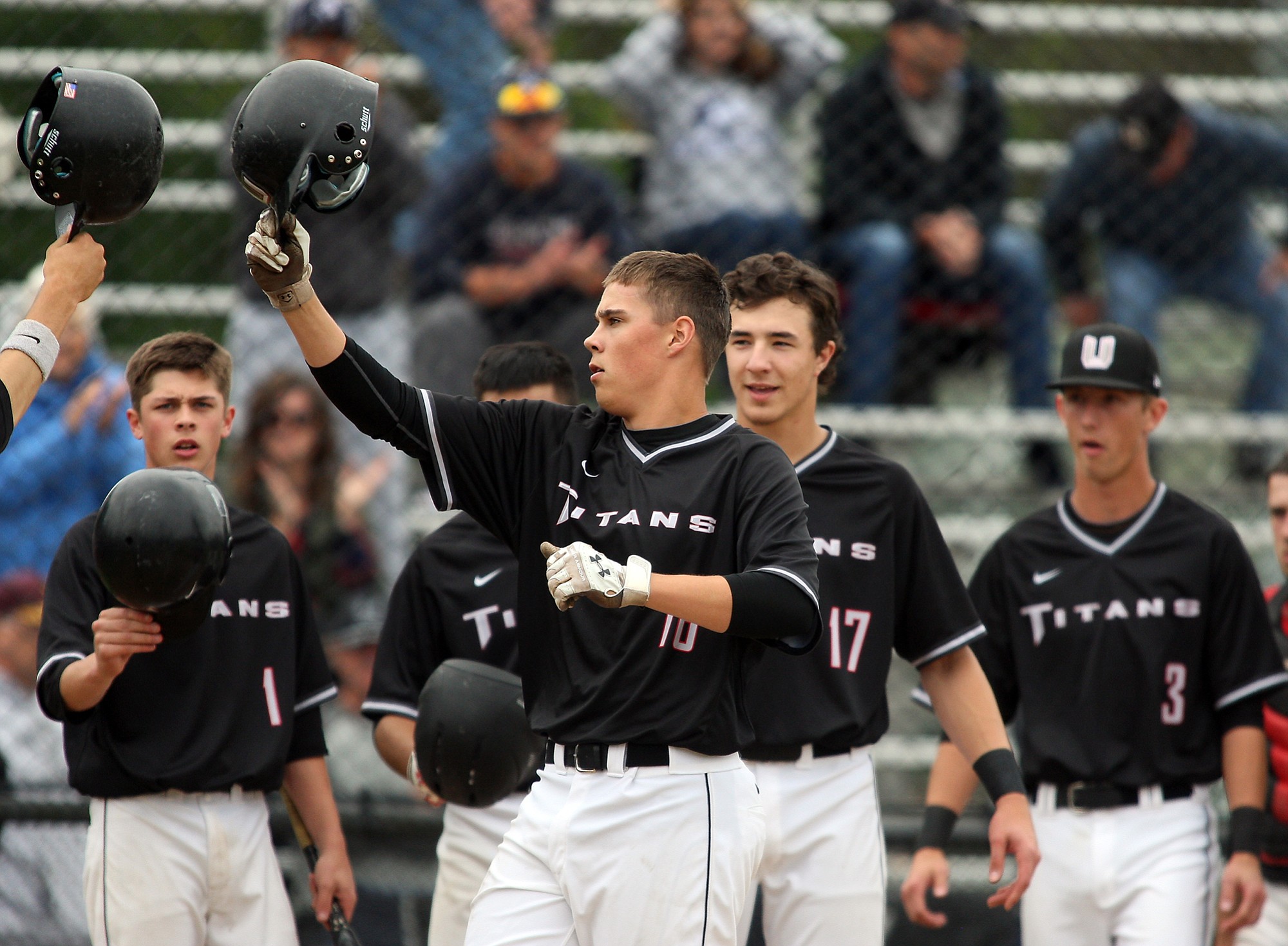 Union's Cody Hawken (16) bumps helmets with teammates after hitting a two run homer in the 1st inning against Kentwood in 4A WIAA State Baseball tournament at Hiedelberg Park in Tacoma on May 23.
