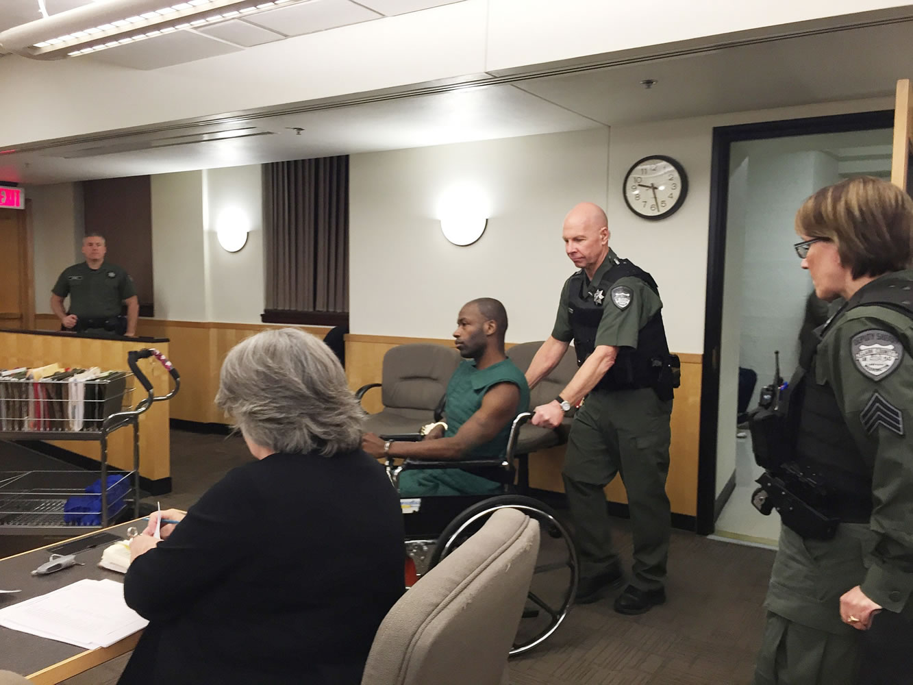 Paris Achen/The Columbian
A corrections officer pushes Gregory Wright, in wheelchair, into Clark County Superior Court. Wright appeared Thursday on suspicion of first-degree kidnapping and second-degree assault of a mental health counselor.
