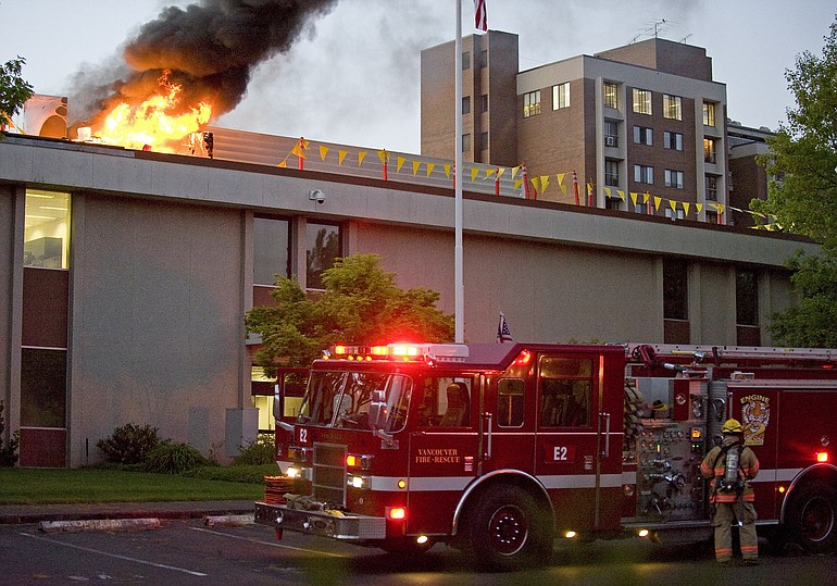 Firefighters respond to a fire on the roof of the Federal Building in downtown Vancouver on Thursday .