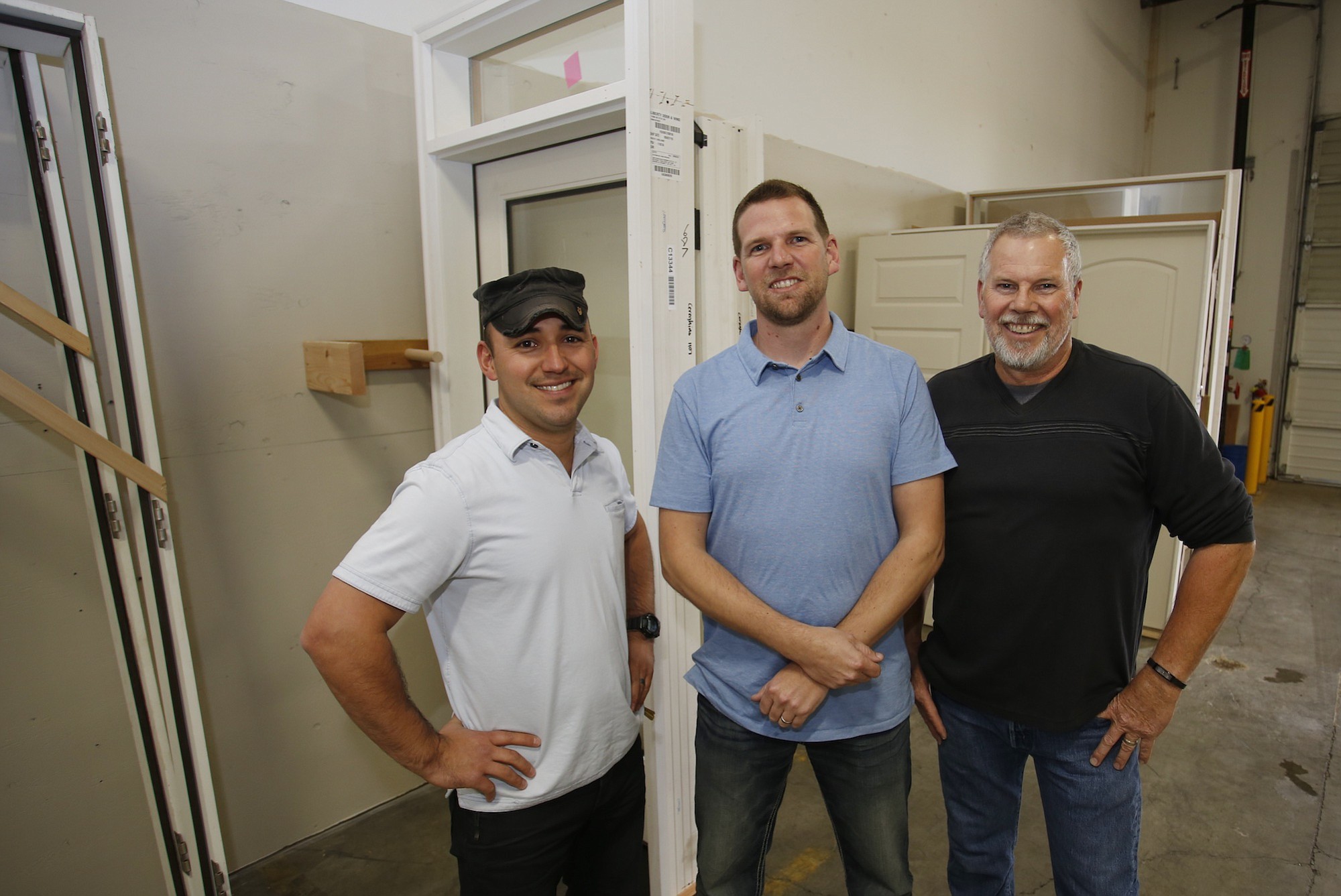 Liberty Door &amp; Window co-owners , from left, Felipe Hernandez, J.R. Hunter and Randy Hunter at the warehouse for the new company.  Liberty plans to open a display showcase at the warehouse, located at 11006 N.E.