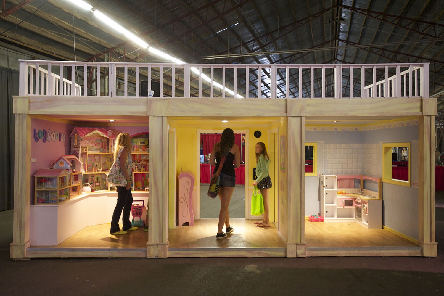 Visitors explore a life-size dollhouse at the interactive Toytopia exhibit at the Clark County Fair this week.