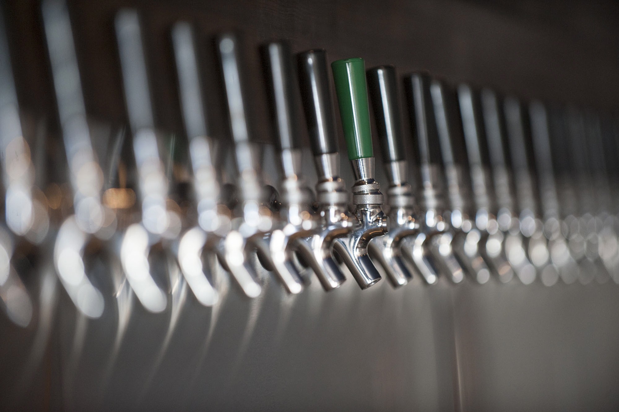 A long row of taps is seen at the new taproom Grapes 'n Growlers in east Vancouver.