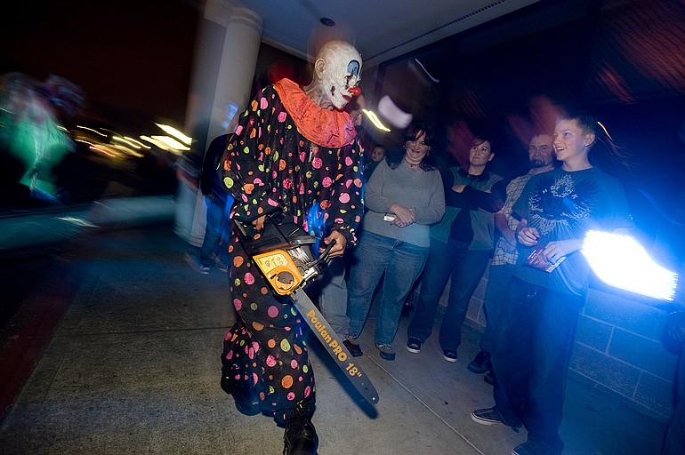 Crazed clowns terrorize visitors to the Scream Haunted House at Vancouver Plaza