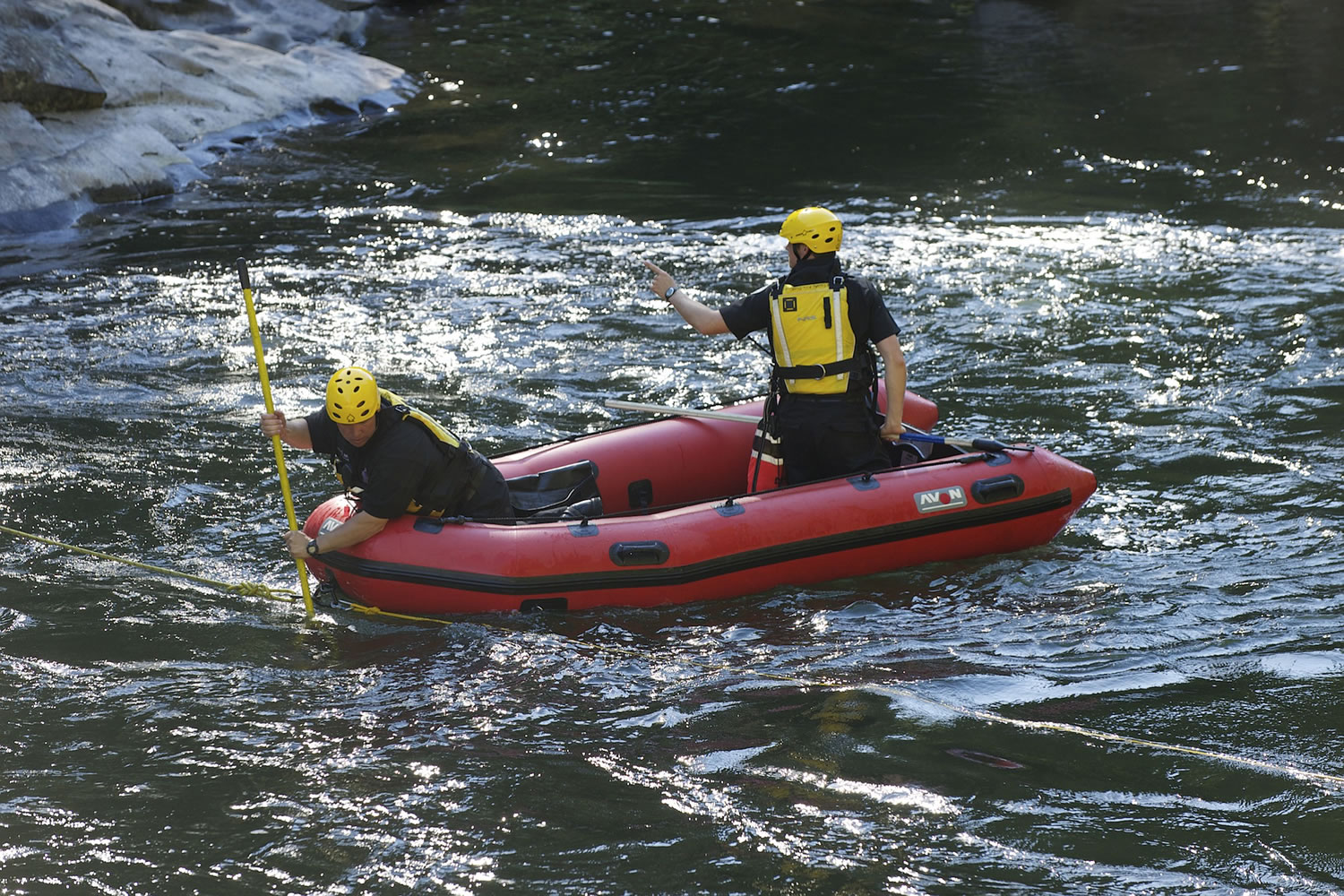 Rescue personnel from North Country EMS search the East Fork of the Lewis River below Moulton Falls on Tuesday for a man who drowned.
