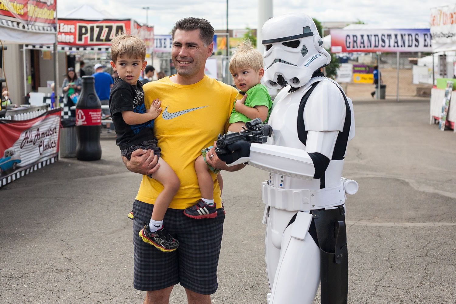 A Stormtrooper poses with Jason Beatty and his sons Ryan, 3 and Derek, 1 at the Clark County Fair on Saturday.