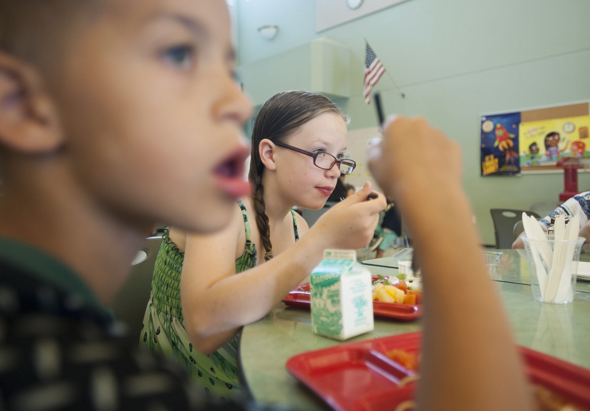 Siblings Chance 8, left, and Ashton Kalahan, 12, eat a free spaghetti lunch Wednesday at Fruit Valley Elementary School in Vancouver.