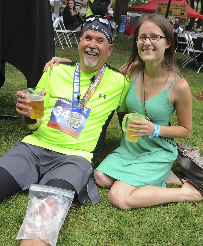 Todd Heide enjoys a beer, an ice pack and Father's Day with daughter Tylene Heide during Summer Brewfest at Esther Short Park in Vancouver.
