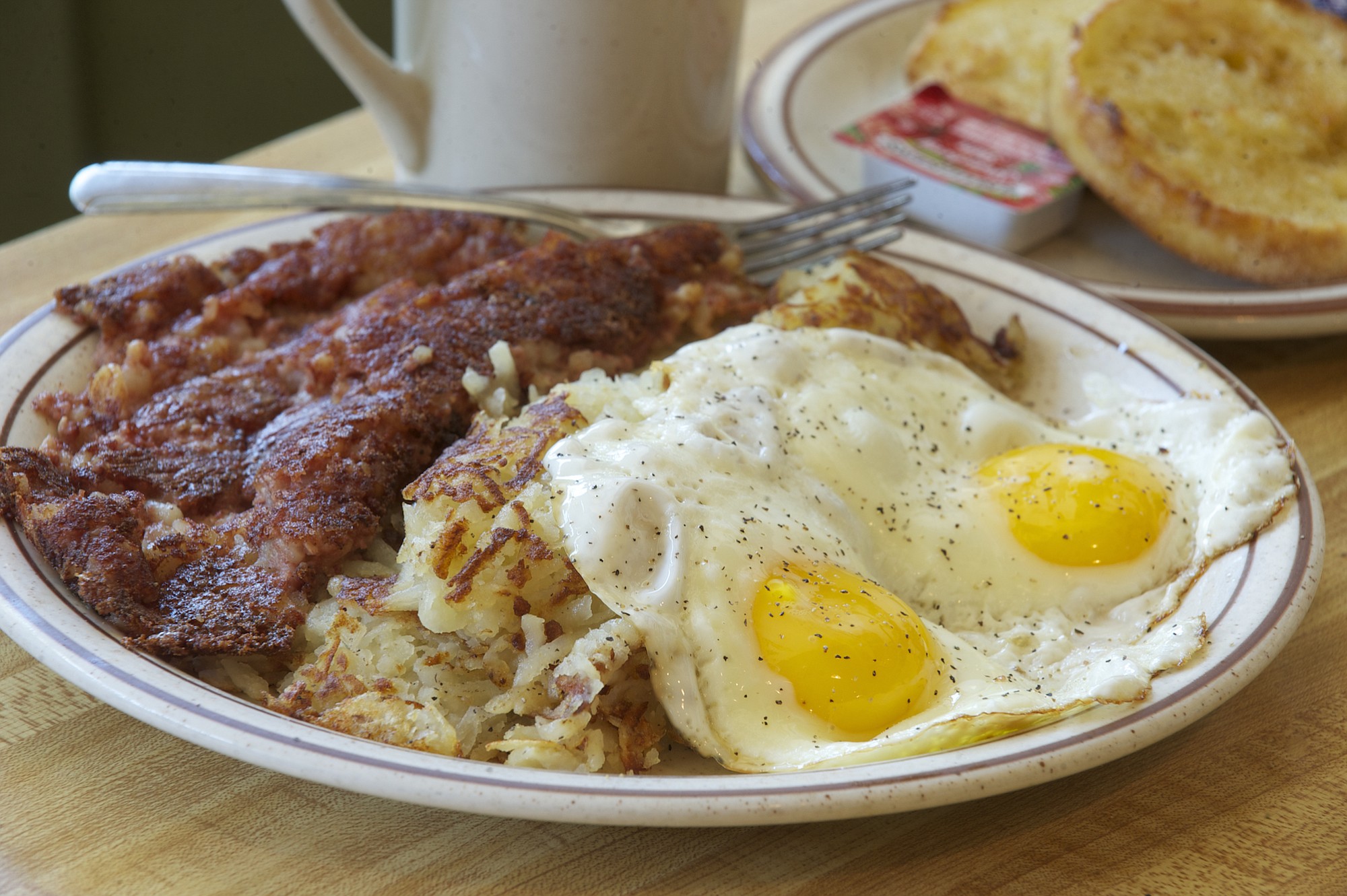 Corned beef hash, hash browns and sunny-side-up eggs with an English muffin and coffee at Joe Brown's Cafe.