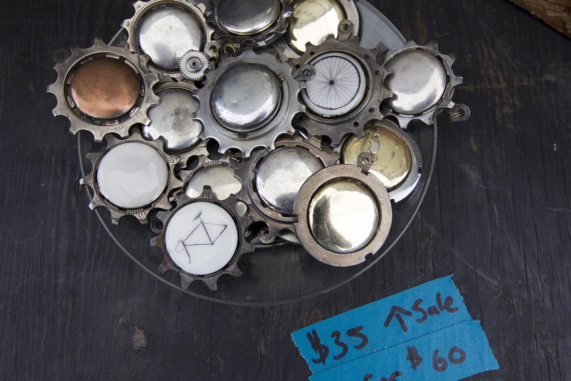 Lockets made from bike parts by artist Johnnie Olivan are for sale Sunday at the Recycled Arts Festival.