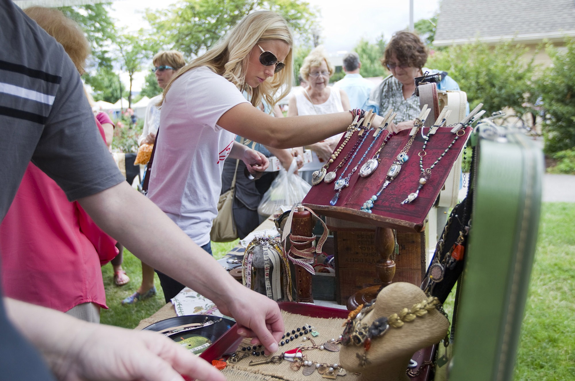 At the Recycled Arts Festival on Sunday, Sara Turner of Vancouver, center, looks at jewelry made from recycled items.
