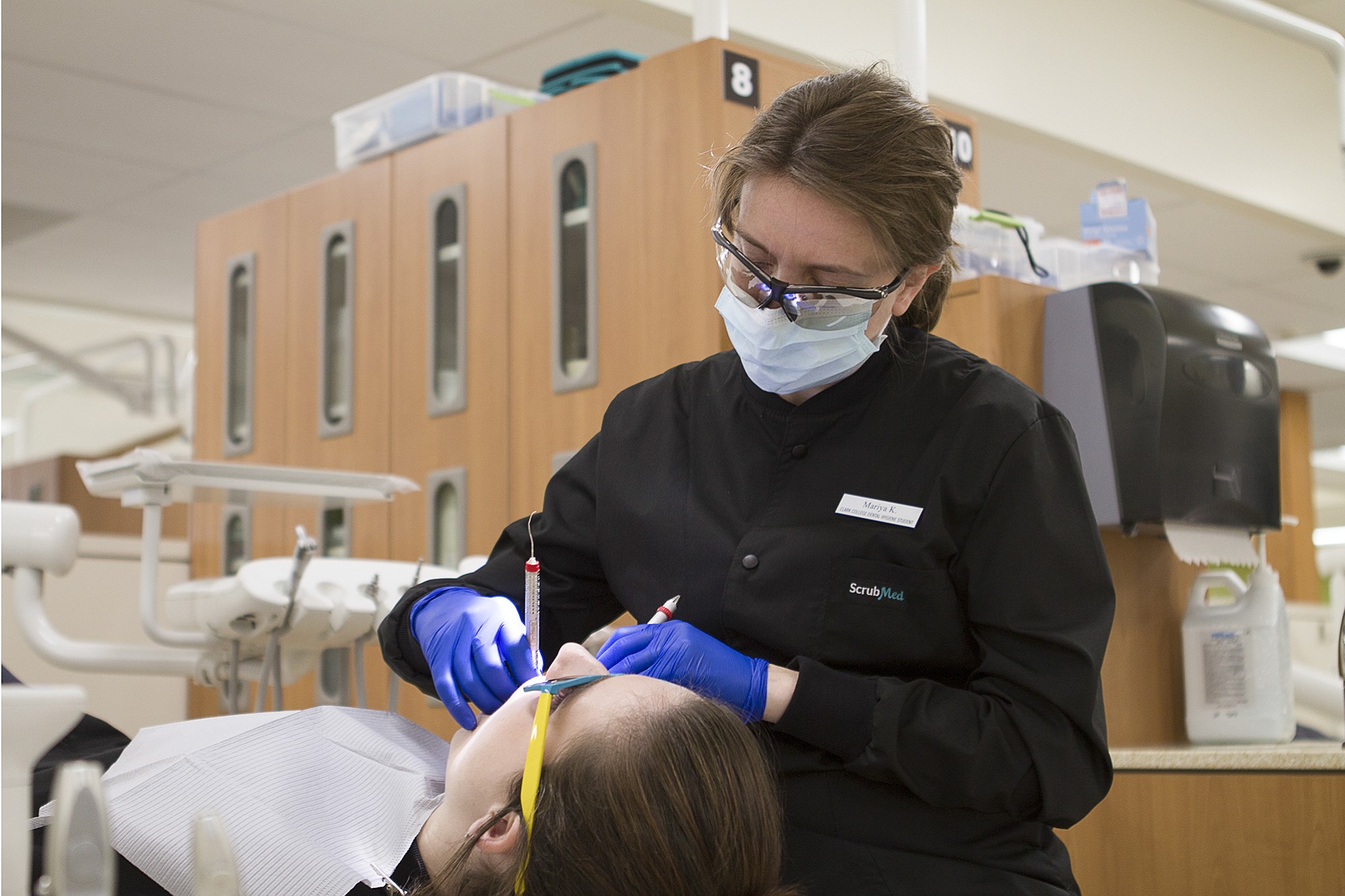 First-year dental hygiene student Mariya Kravchenka works on classmate Kiana Walker during clinical training at Clark College's Firstenburg Family Dental Hygiene Education and Care Center.