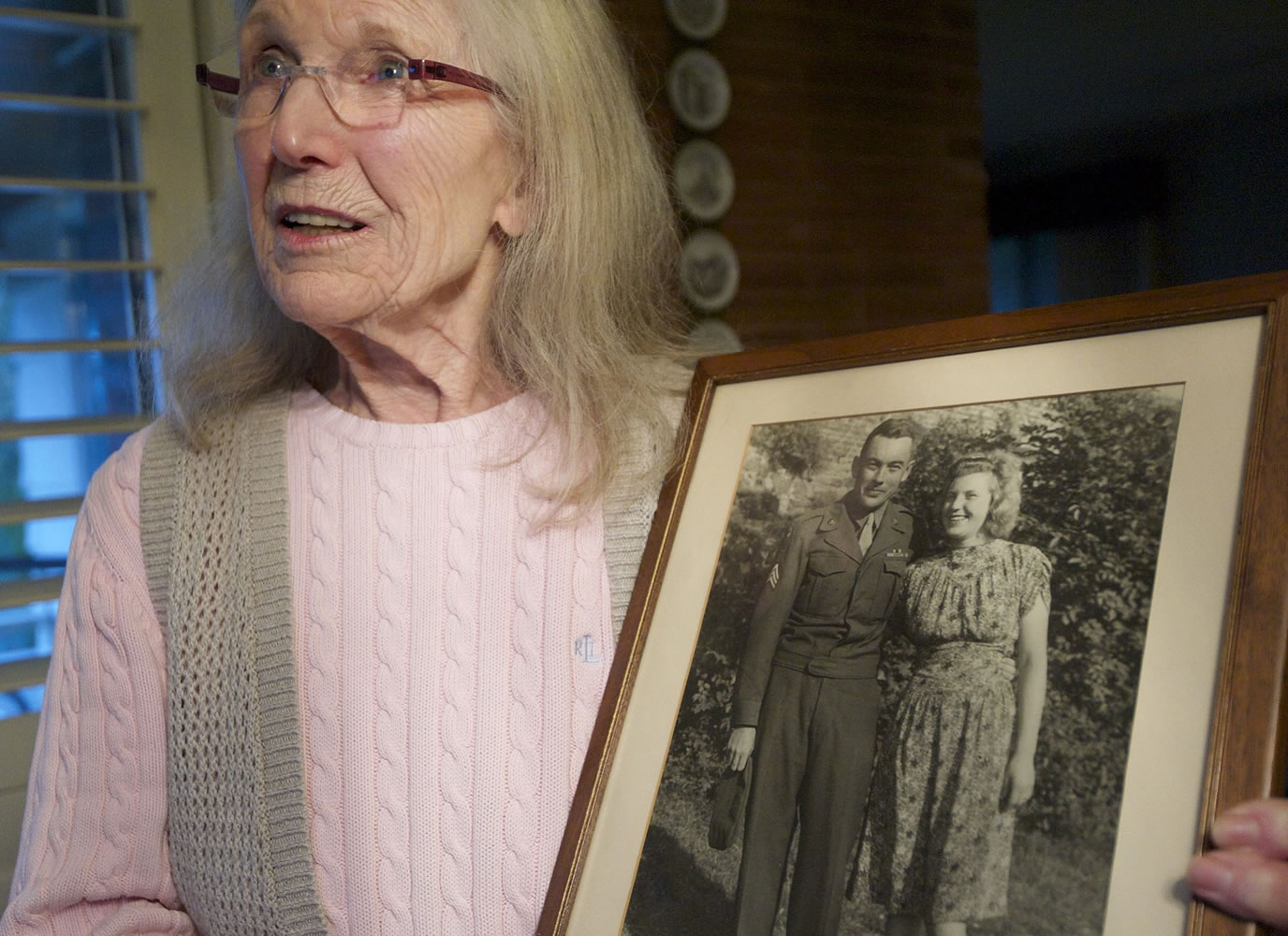 Gerda McMillan holds a 66-year-old old photograph of herself and her late husband taken during the American occupation of Germany following World War II.