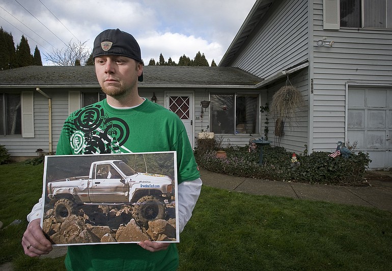 Darus Gieseman holds a photograph of his 1986 Toyota 4X4 truck, which was stolen from the backyard of his family's home earlier this month.