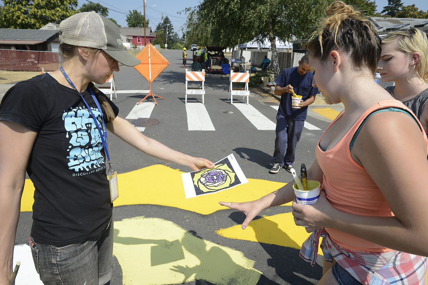 Ariane Kunze/The Columbian
Discovery Middle School art teacher Miranda Wakeman (left) and Haven Rinehart, 12, review plans for a street mural at the corner of East 33rd and R streets in Rose Village. The attention-getting mural is meant to discourage drivers from speeding through the neighborhood.