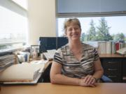 Melanie Payne, an epidemiologist for Clark County Public Health, sits in her office in the Public Health Building in Vancouver.