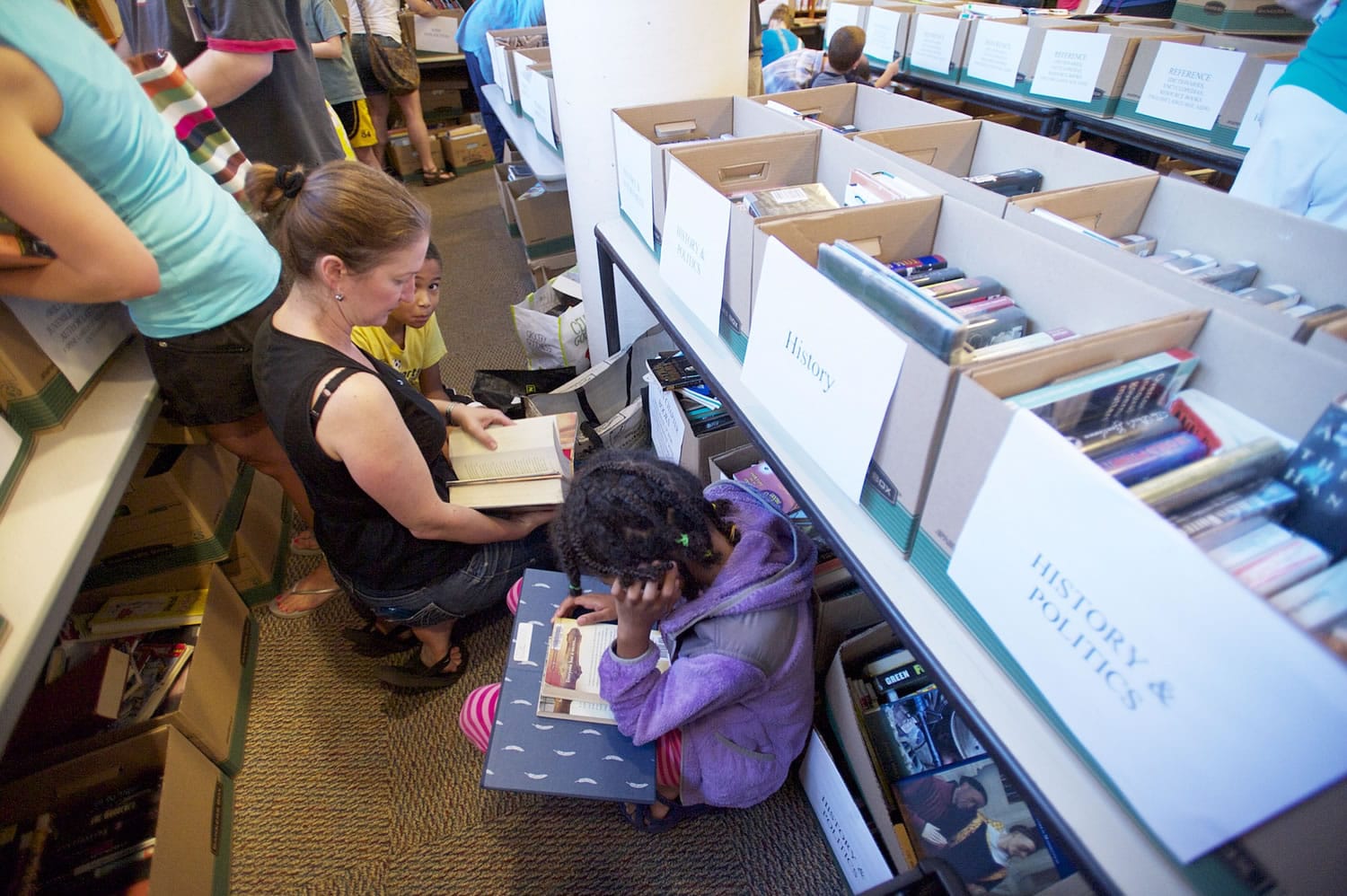 The Tsikayi family from Hockinson, from left, mom Chris, son Isaiah, 9, and Victoria, 10, were among the bargain-hunting bibliophiles at Bookfest '15, the Fort Vancouver Regional Library Foundation's summer super sale Friday.
