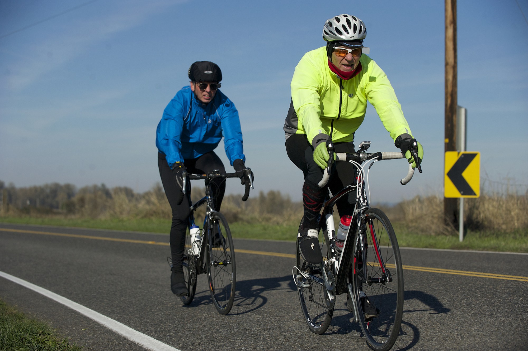 Glenn Teague, in front, followed by Dale Meier ride down Lower River Road from Frenchman's Bar Park Monday.