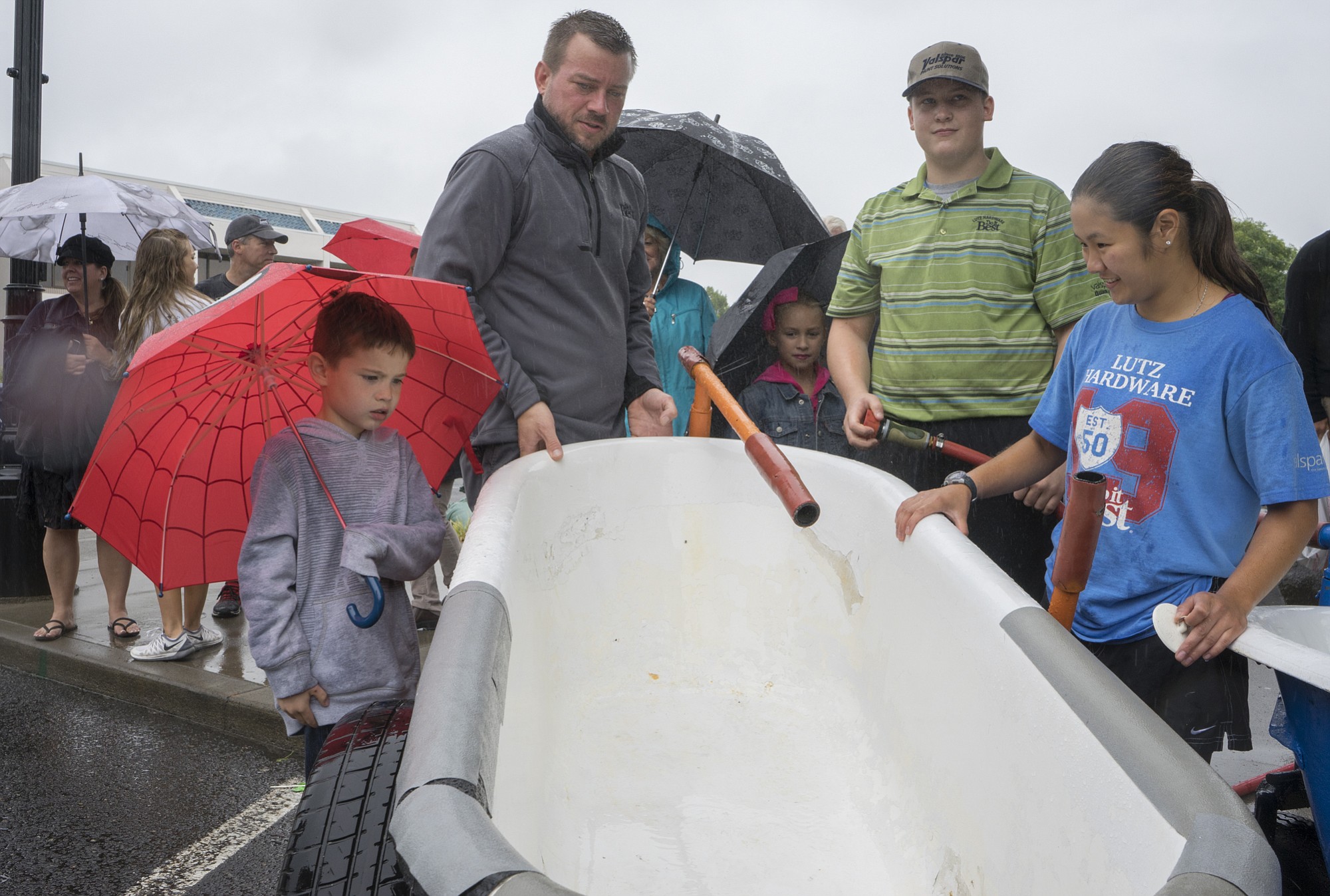 From right to left: Shauna Ahearn, Gaylor Rowland and Aaron Lutz prepare a bathtub before the annual Camas Days race on Saturday.