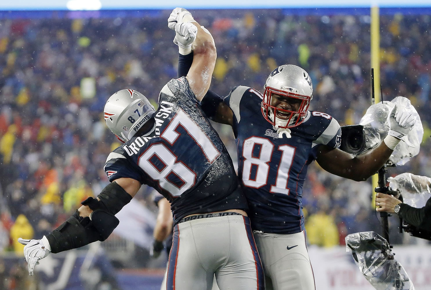 New England Patriots tight end Rob Gronkowski (87) celebrates with teammate Timothy Wright after his 5-yard touchdown catch during the second half of the AFC Championship game against the Indianapolis Colts on Sunday, Jan. 18, 2015, in Foxborough, Mass.