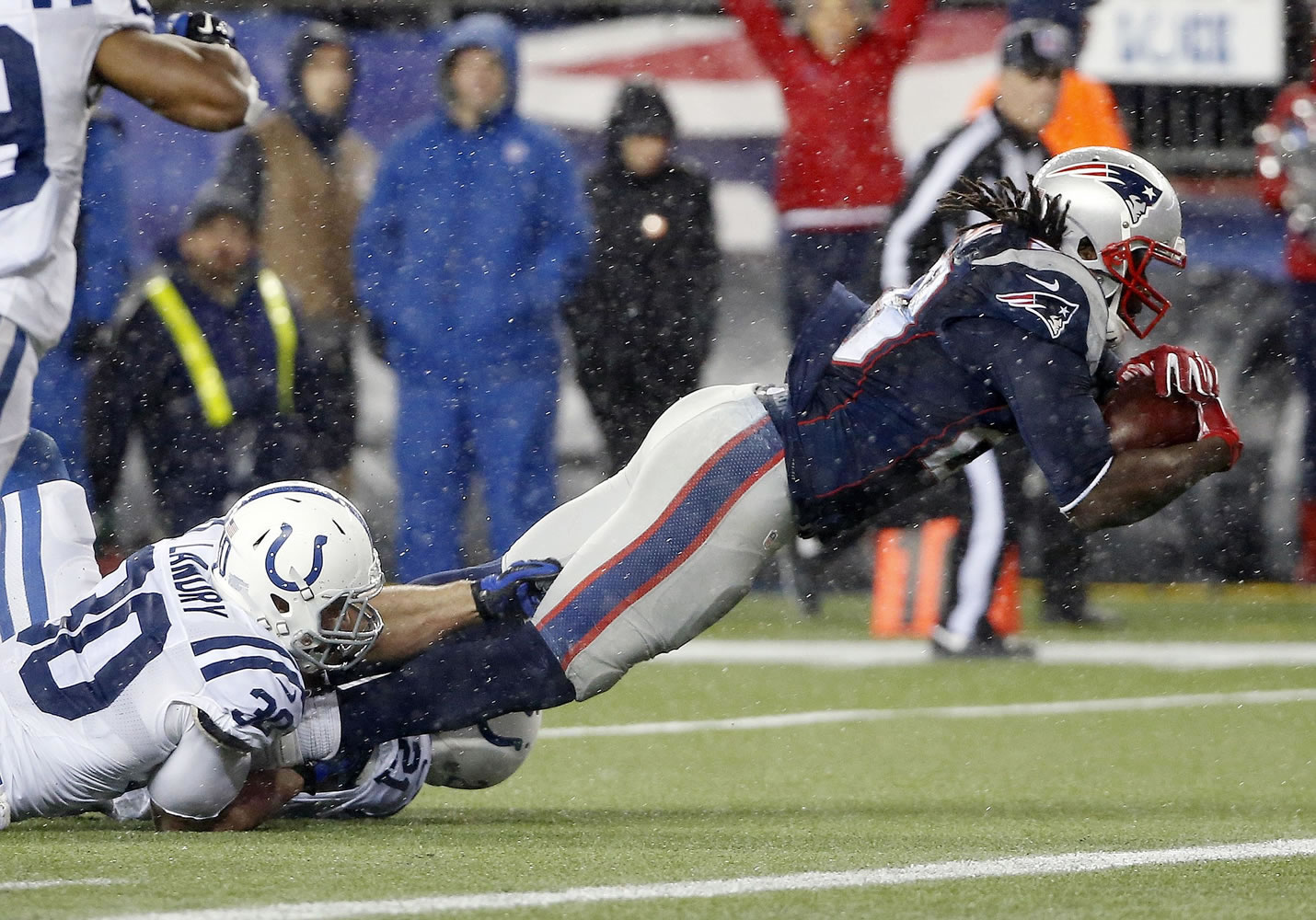 New England Patriots running back LeGarrette Blount (29) scores on a 13-yard touchdown run while being tackled by Indianapolis Colts free safety LaRon Landry during the second half of the NFL football AFC Championship game Sunday in Foxborough, Mass.
