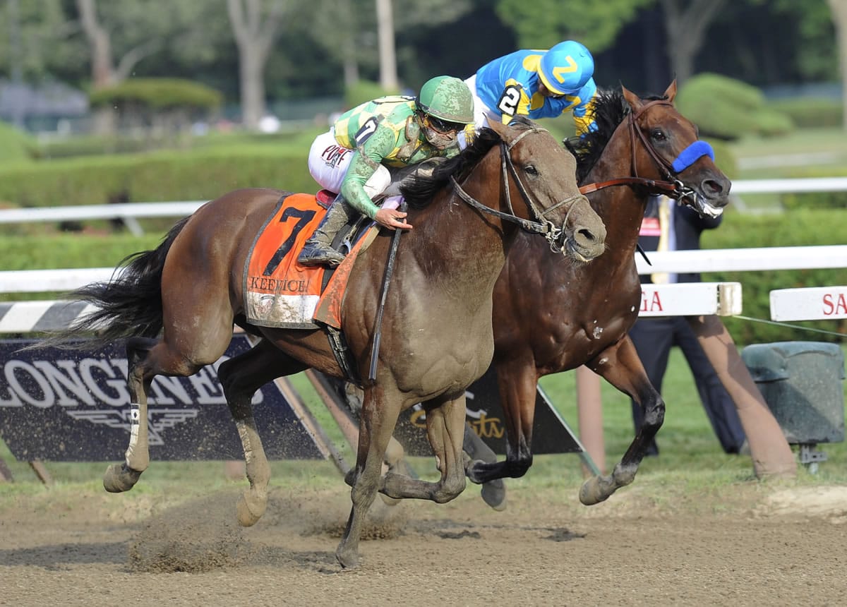 Keen Ice (7), with Javier Castellano, moves past Triple Crown winner American Pharoah, with Victor Espinoza, to win the Travers Stakes horse race at Saratoga Race Course in Saratoga Springs, N.Y., Saturday, Aug. 29, 2015.