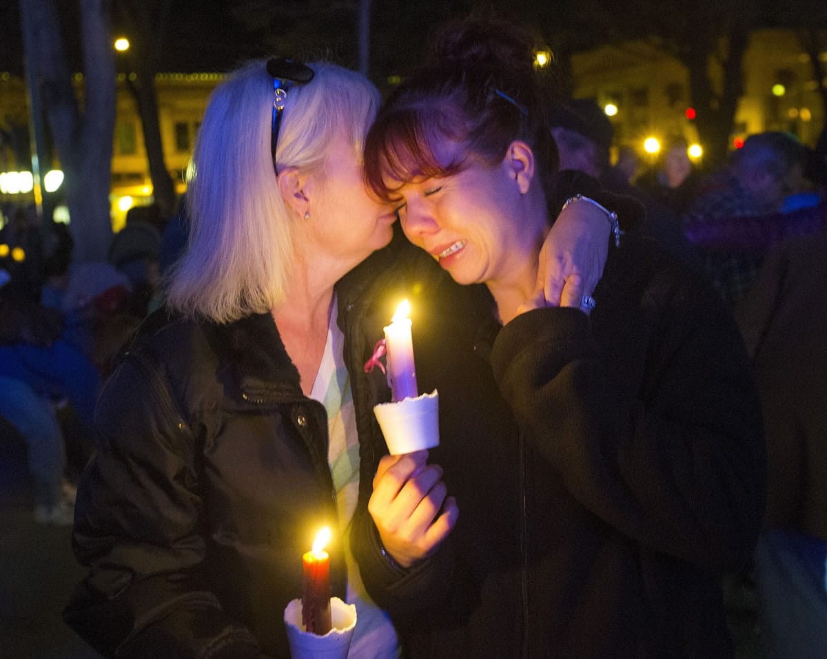 Tonya Castillo, left, comforts her daughter Tiffany Reid during a candlelight memorial for Kayla Mueller in Prescott, Ariz., on Wednesday. Kayla Mueller's death earlier this month was confirmed by her family and U.S. officials.