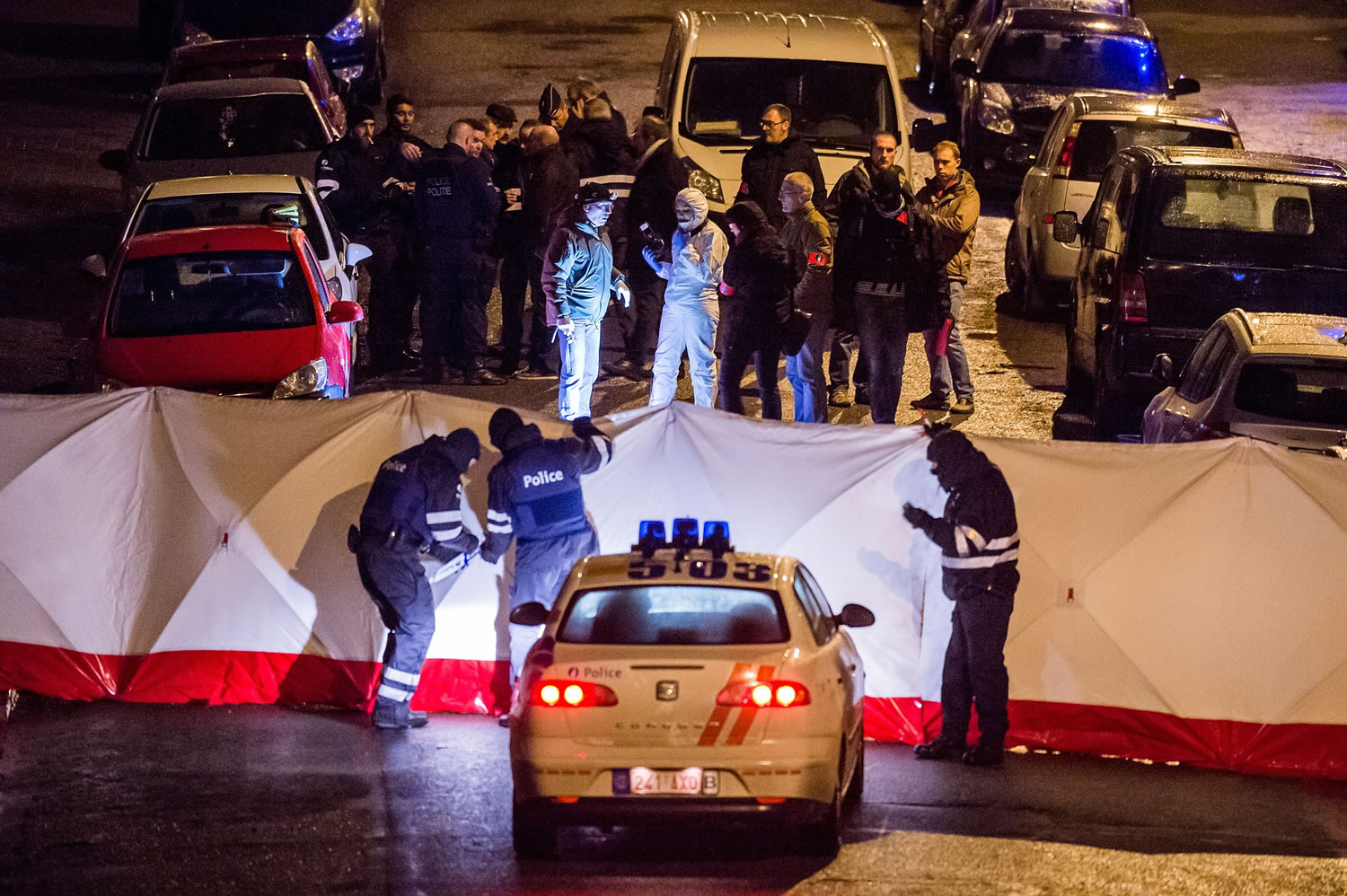 Police investigate a shootout in a street Thursday in Verviers, Belgium.