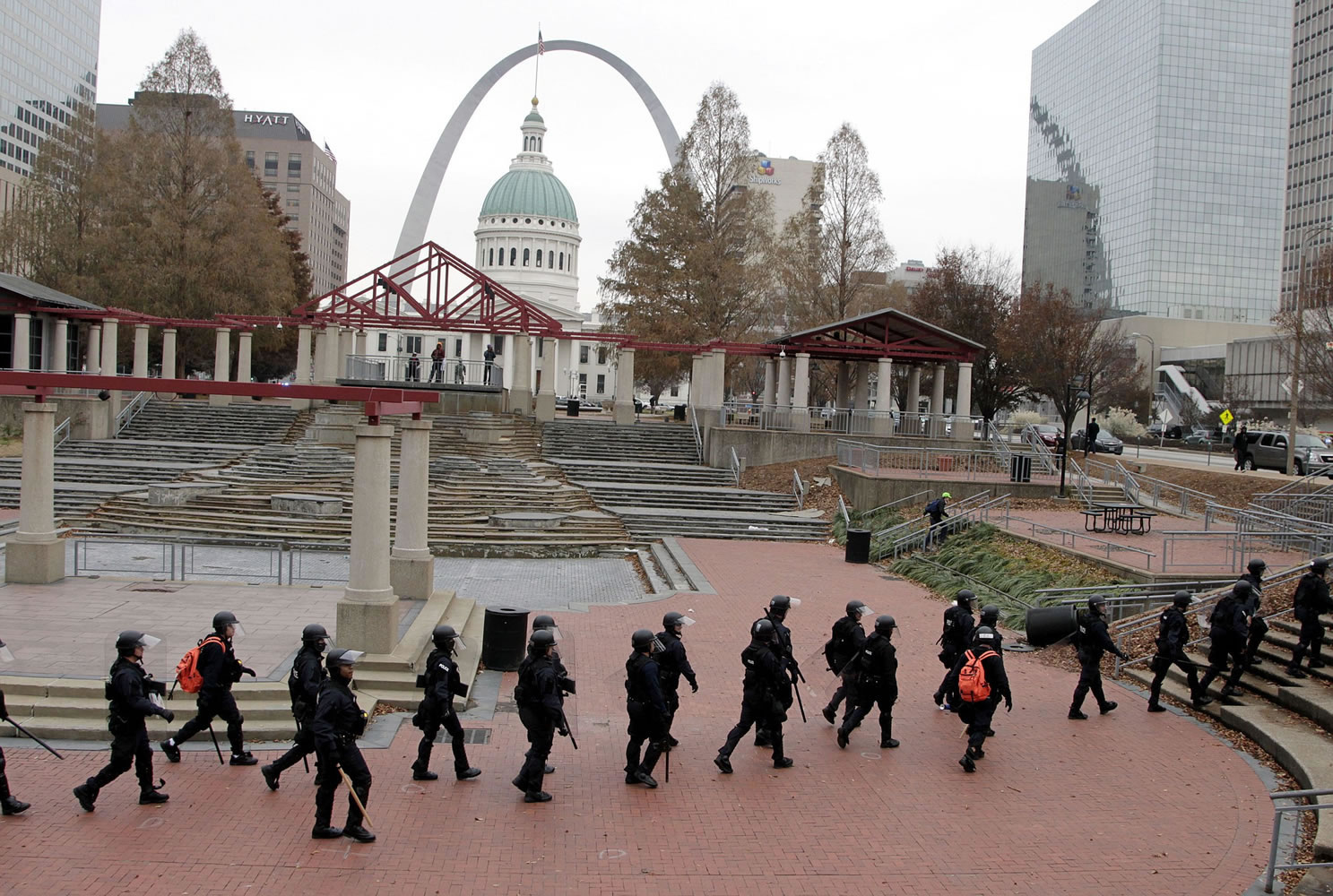 Officers wearing riot gear walk through a park Sunday in downtown St. Louis. Police and protesters clashed after an NFL football game between the St.