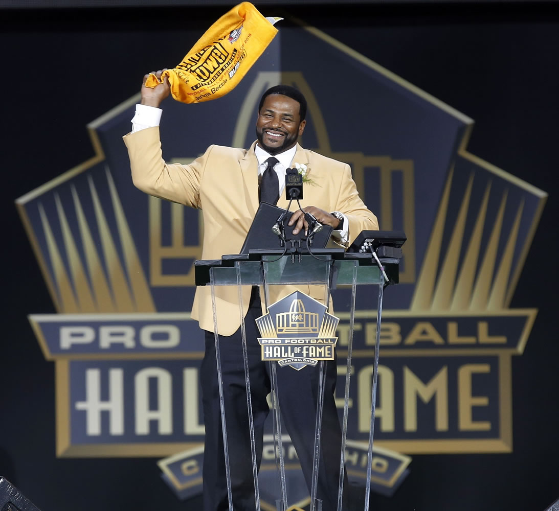 Former NFL player Jerome Bettis waves a Terrible Towel at the conclusion of his speech during inductions at the Pro Football Hall of Fame on Saturday, Aug.