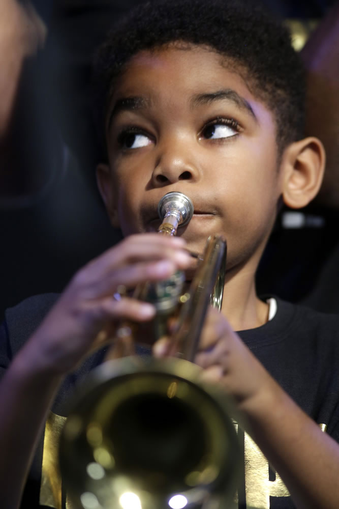 Deuce Brown, 6, plays trumpet with the band Trumpet Mafia on Thursday at the New Orleans Jazz and Heritage Festival.