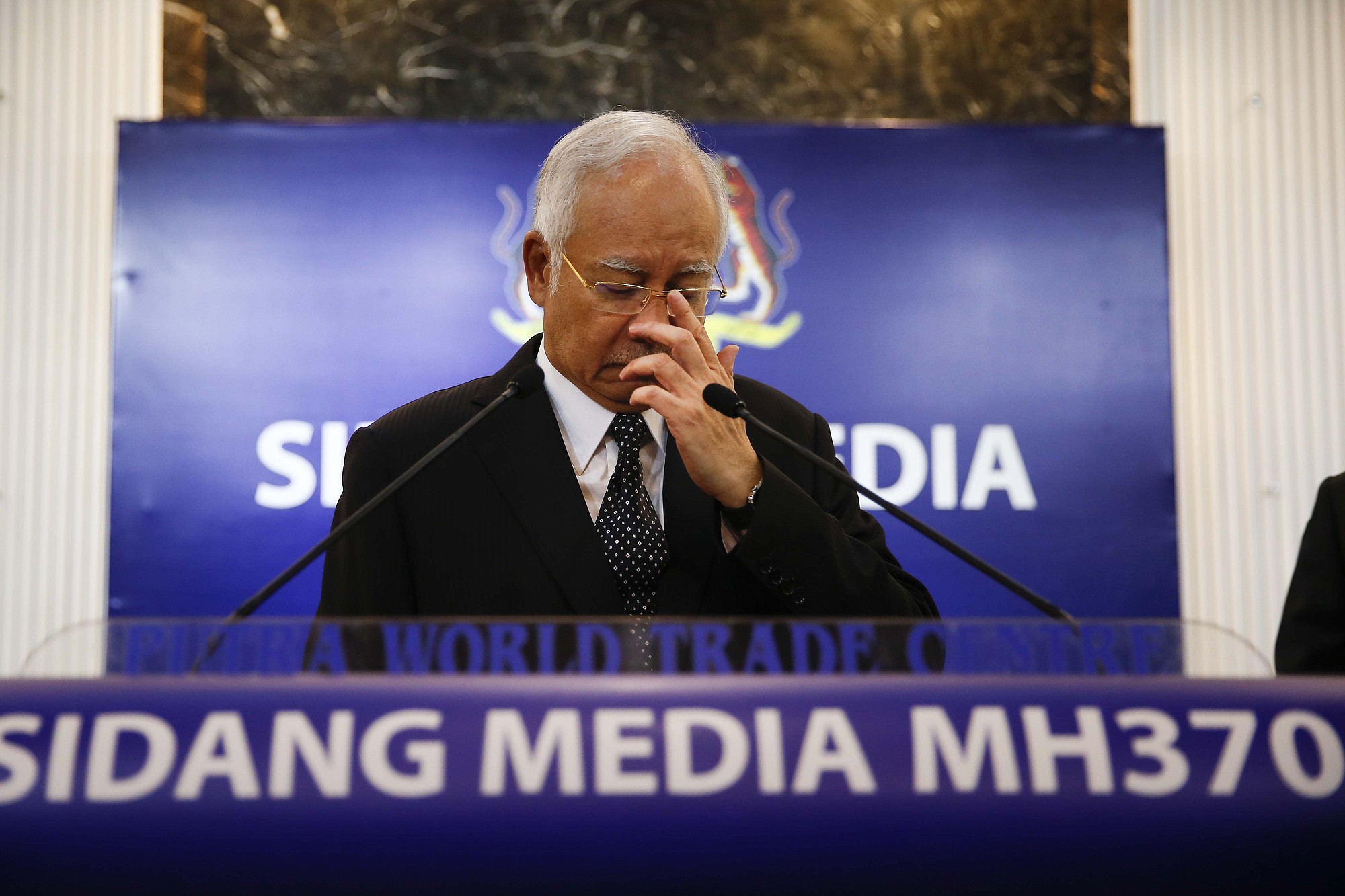 Malaysian Prime Minister Najib Razak, center, gestures before speaking at a special press conference announcing the findings for the ill fated flight MH370 in Kuala Lumpur, Malaysia, early Thursday.