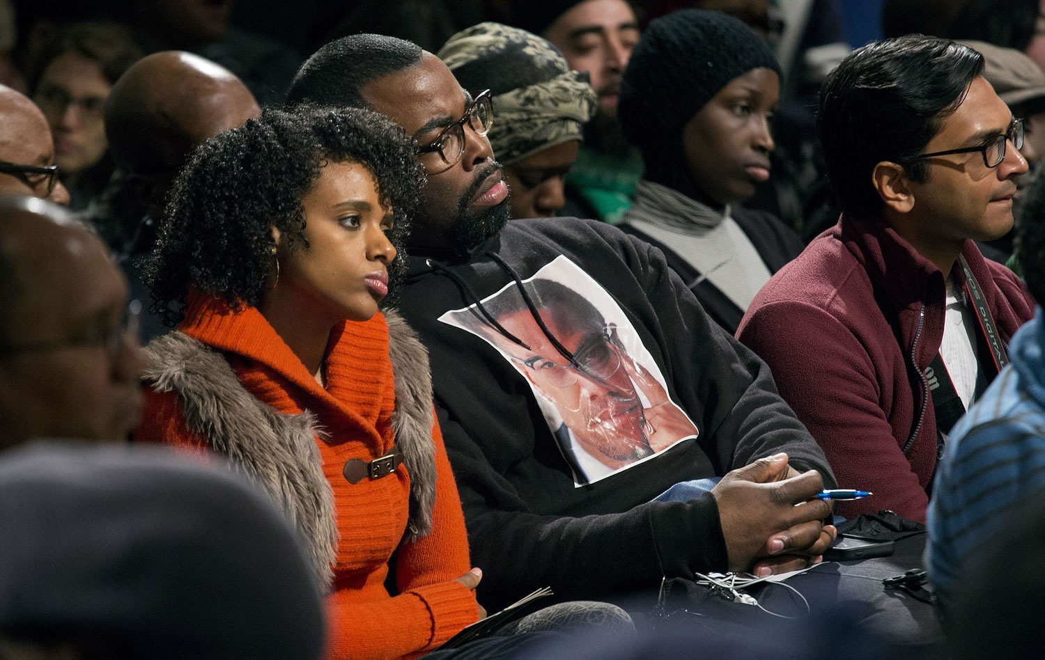 Rahiel Tesfamariam, left, and Raschaad Hoggard, both of New York, listen Saturday during comments as activists, actors, and politicians remember civil rights leader Malcolm X during a ceremony at the site in Harlem where he was killed 50 years ago.
