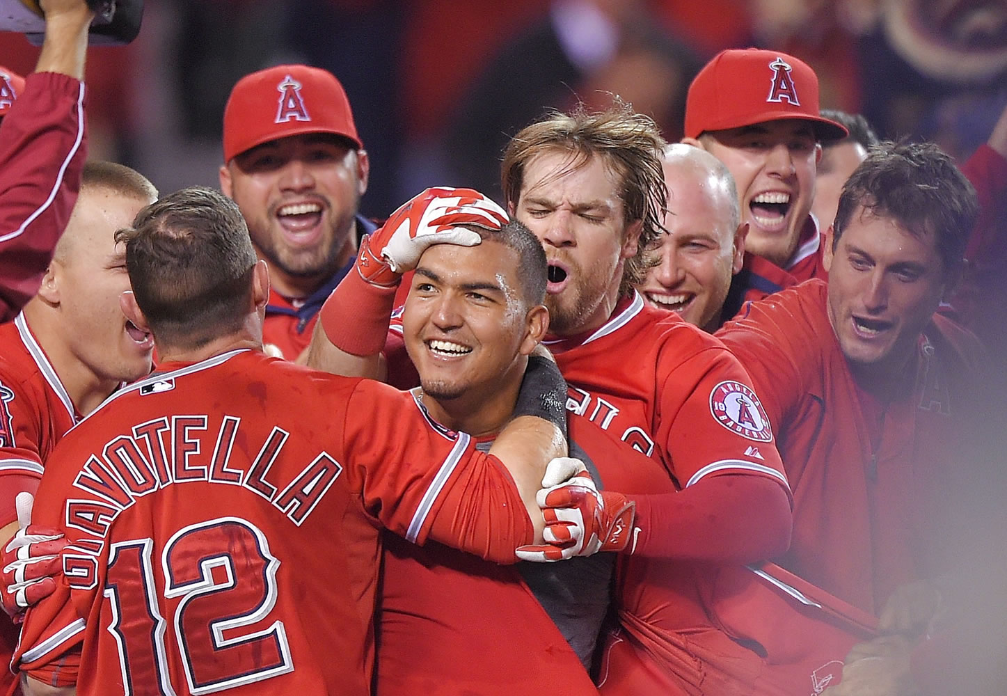 Los Angeles Angels' Carlos Perez, center, is surrounded by teammates after hitting a walk-off home run to beat the Seattle Mariners 5-4 in the ninth inning of a baseball game Tuesday, May 5, 2015, in Anaheim, Calif. (AP Photo/Mark J.