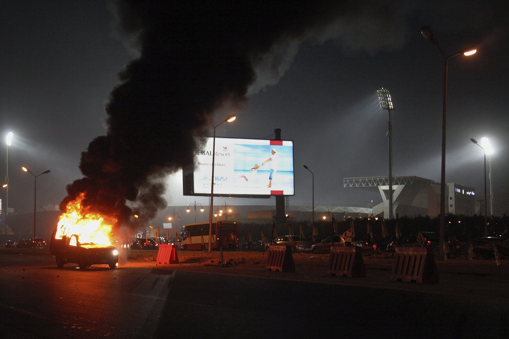 A pickup truck bursts into flames Sunday as a riot breaks out outside of a soccer match between Egyptian Premier League clubs Zamalek and ENPPI at Air Defense Stadium in a suburb east of Cairo, Egypt.