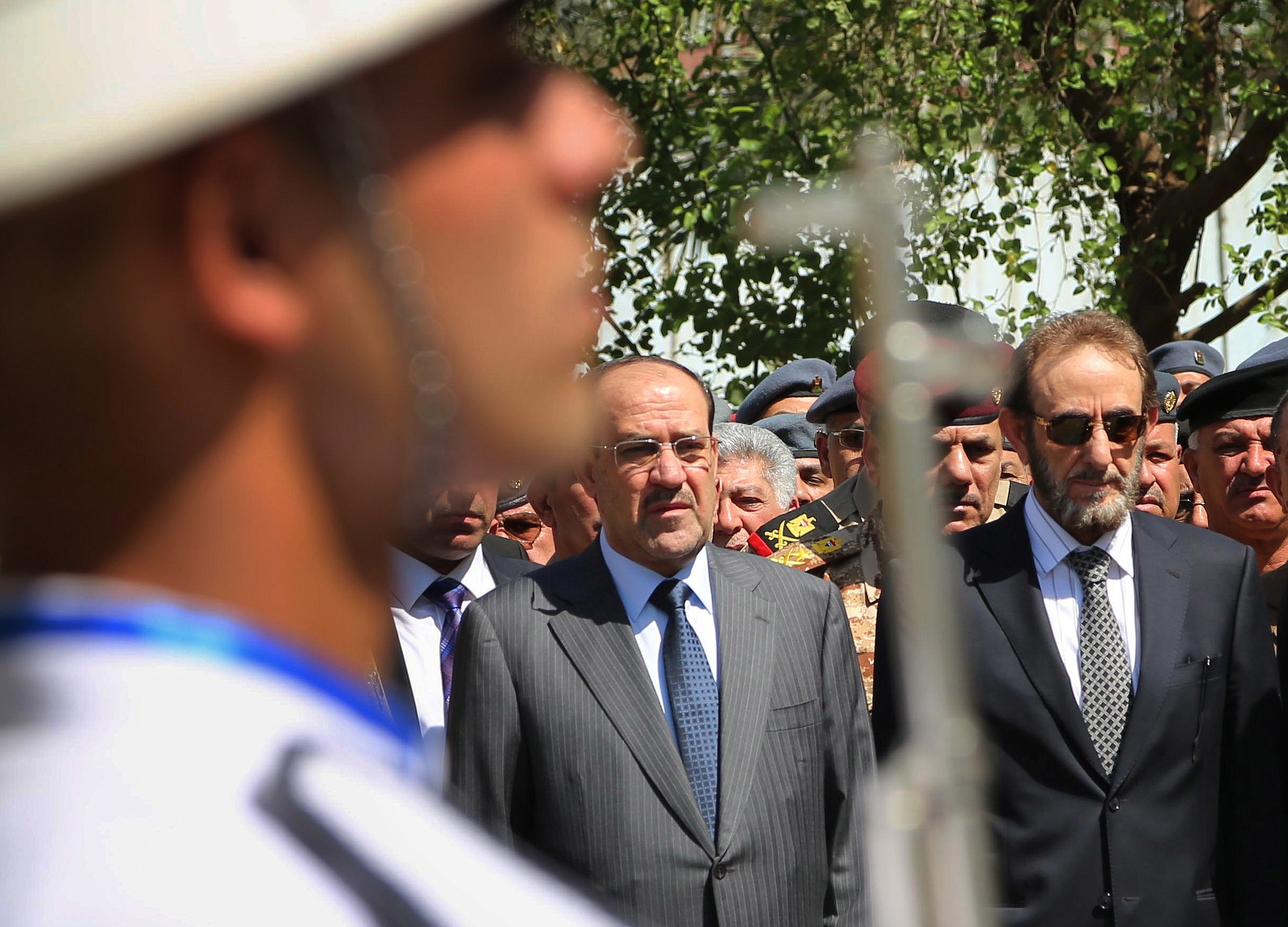 Iraqi Prime Minister Nouri al-Maliki, center, Iraqi acting Defense Minister Sadun al-Dulaymi, right, government officials and parliament members attend the funeral procession of Maj. Gen.