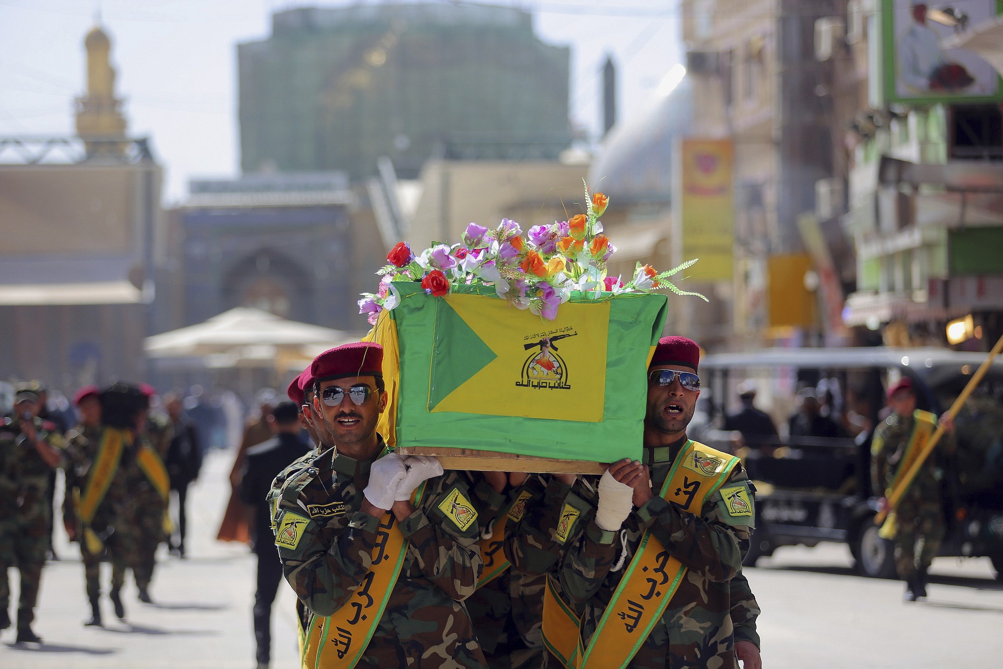 Iraqi Hezbollah fighters carry the coffin of their comrade, Ali Mansour, who his family says was killed in Tikrit fighting Islamic militants, during his funeral procession, in the Shiite holy city of Najaf, 100 miles south of Baghdad, Iraq, on Monday.