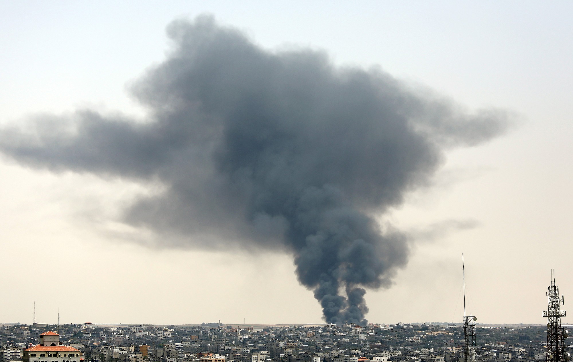 Smoke rises after a cargo crossing between Israel and Gaza was shelled on Saturday, July 12, 2014. Israeli airstrikes targeting Hamas in Gaza hit a mosque and a center for the disabled where two women were killed Saturday, raising the Palestinian death toll from the offensive to more than 120, Palestinian officials said.