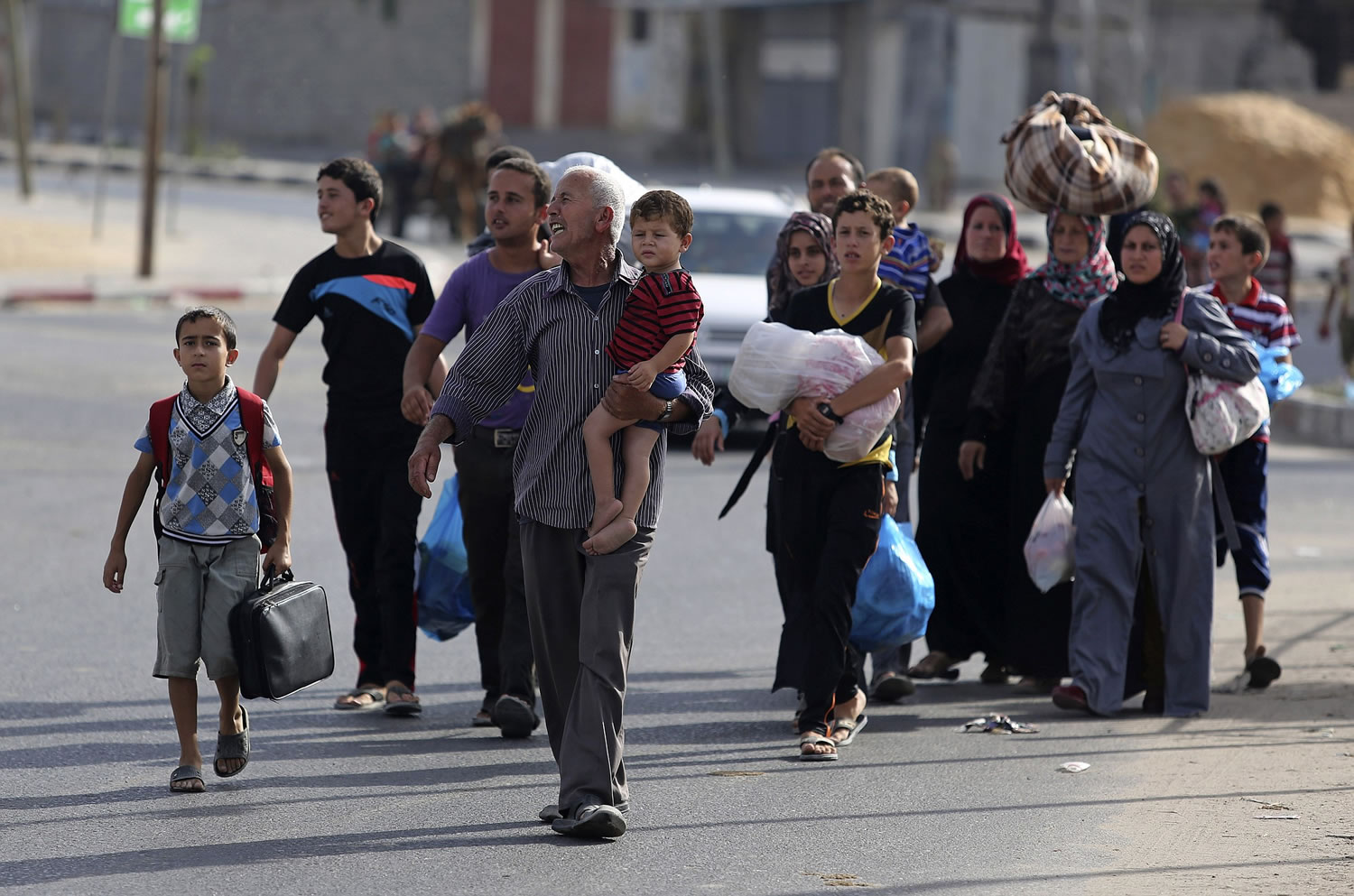 Palestinians flee their homes for shelter at the United Nations school Sunday in Gaza City.