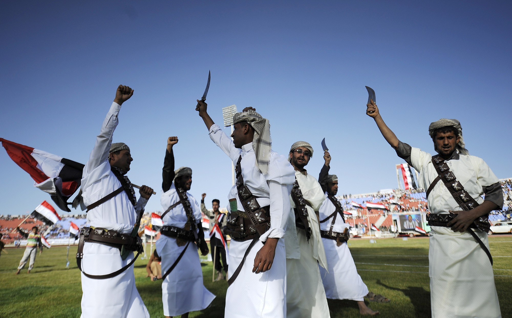 Supporters of Houthi Shiites, who took over the government of Yemen and installed a new committee to govern, wave traditional daggers and chant slogans at a rally at a sports stadium in Sanaa, Yemen, on Saturday,