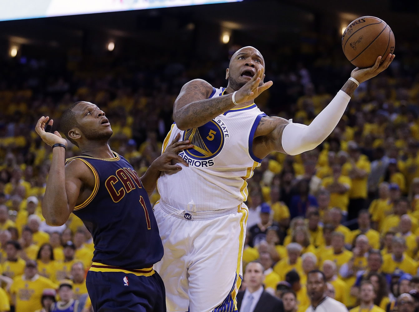 Golden State Warriors forward Marreese Speights (5) shoots against Cleveland Cavaliers forward James Jones (1) during the second half of Game 1 of the NBA Finals in Oakland, Calif.