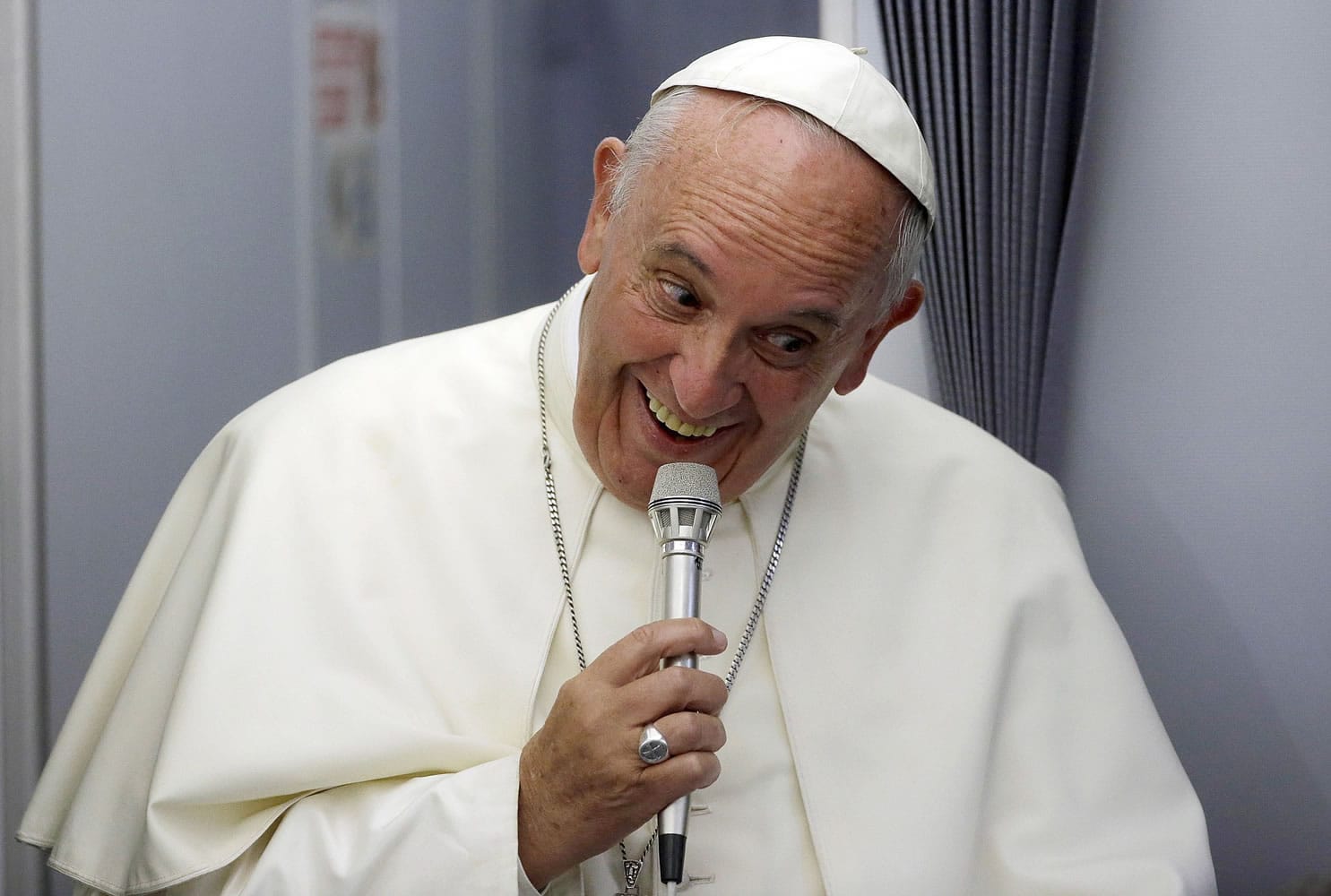 Pope Francis smiles as he meets the media during an airborne press conference aboard the airplane directed to Rome, at the end of his Apostolic journey in Ecuador, Bolivia and Paraguay.