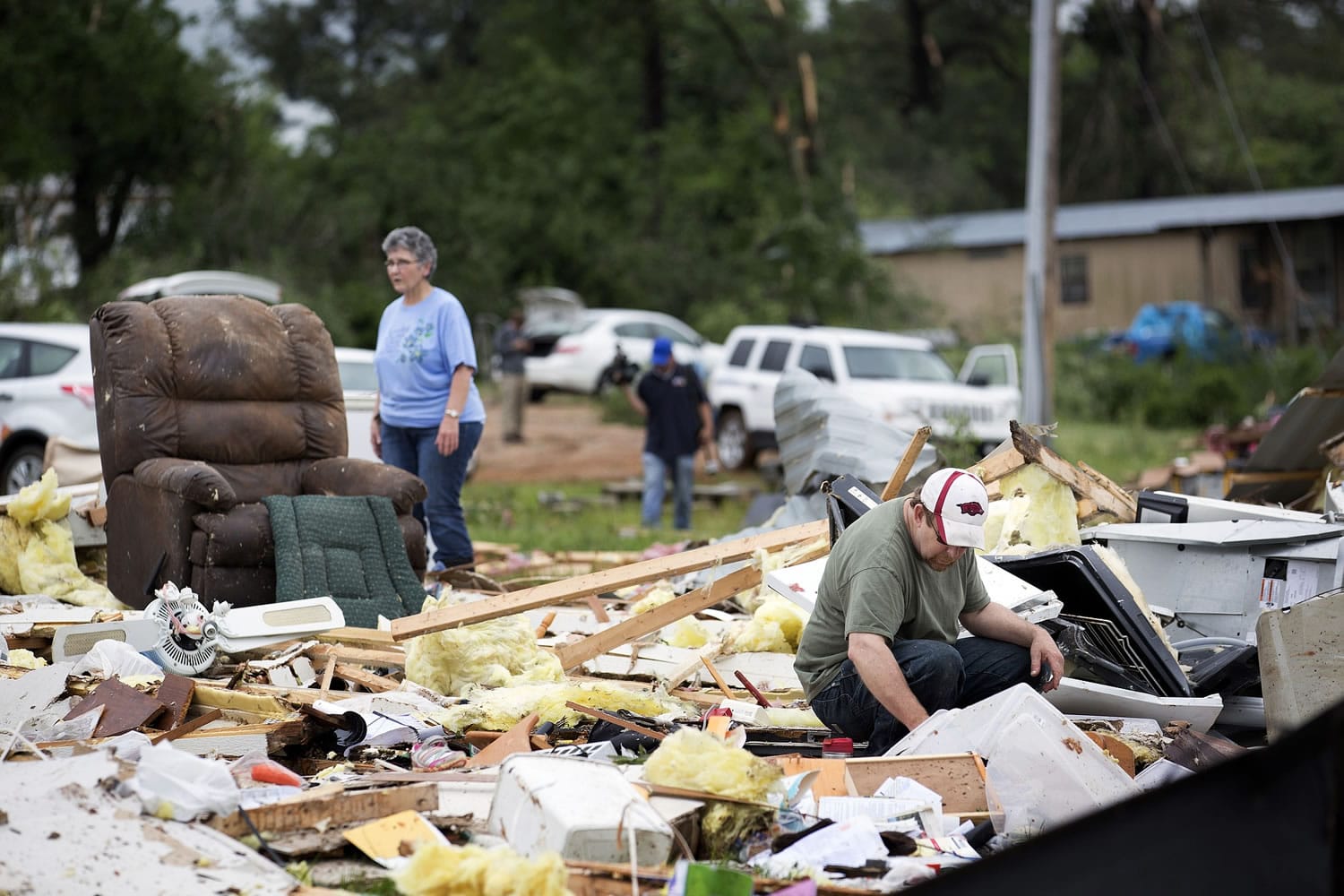 Ronnie Bevill sifts through debris looking for anything salvageable from his aunt's home Monday after a section of the D