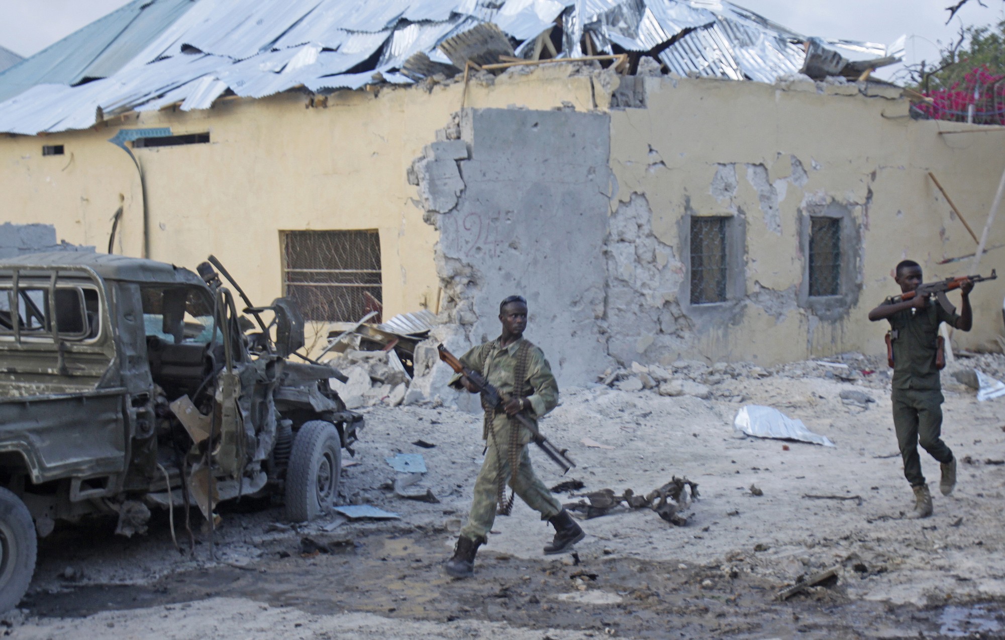 Somali soldiers take up positions after a bomb went off Friday at the gate of a popular hotel in Mogadishu, Somalia.