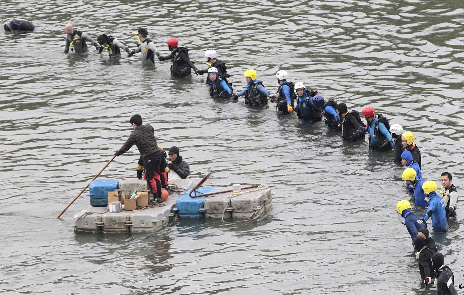 Search and rescue divers continue to search for missing persons Friday at the site of a commercial plane crash in Taipei, Taiwan. TransAsia Airways Flight 235, with 58 people aboard, clipped a bridge shortly after takeoff and crashed into a river in the island's capital of Taipei on Wednesday morning.