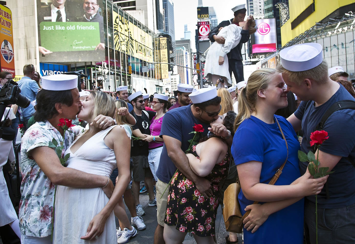 Kenji and Kristen Kawasaki, far left, join others as they re-enact the iconic 1945 Alfred Eisenstaedt kiss photo on Friday in New York's Times Square.